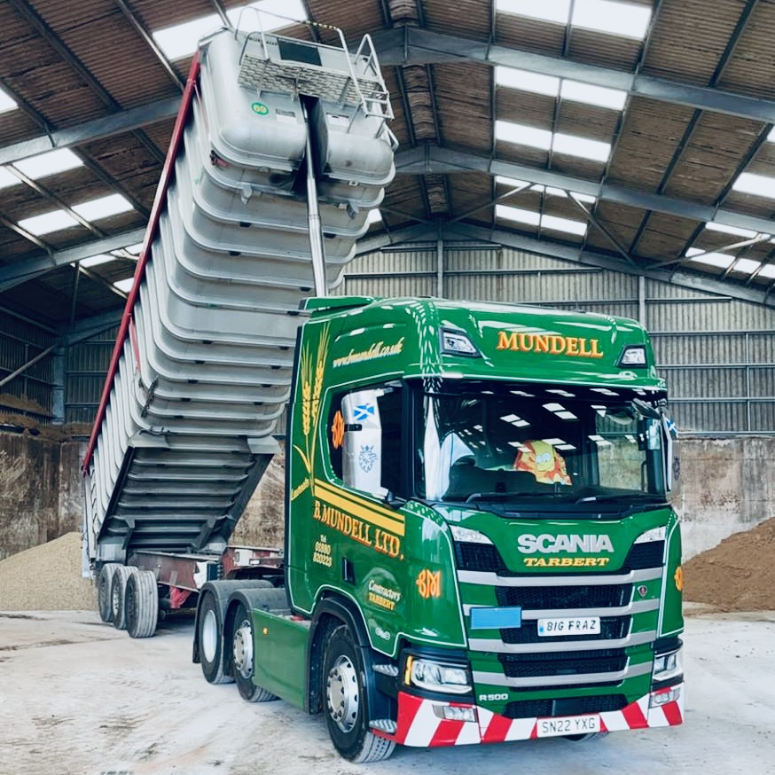 B Mundell Scania tipper raising its trailer in a grain store